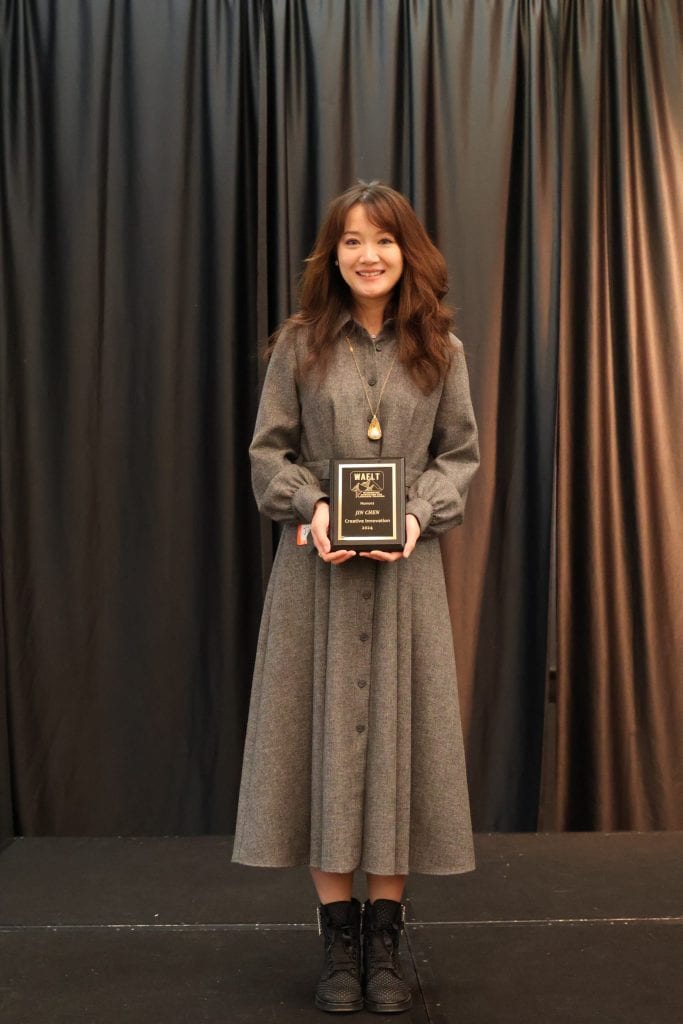 Founder Jin Chen receiving WAFLT Innovation Award for NewConcept Education, a top-rated Chinese school in Bellevue.