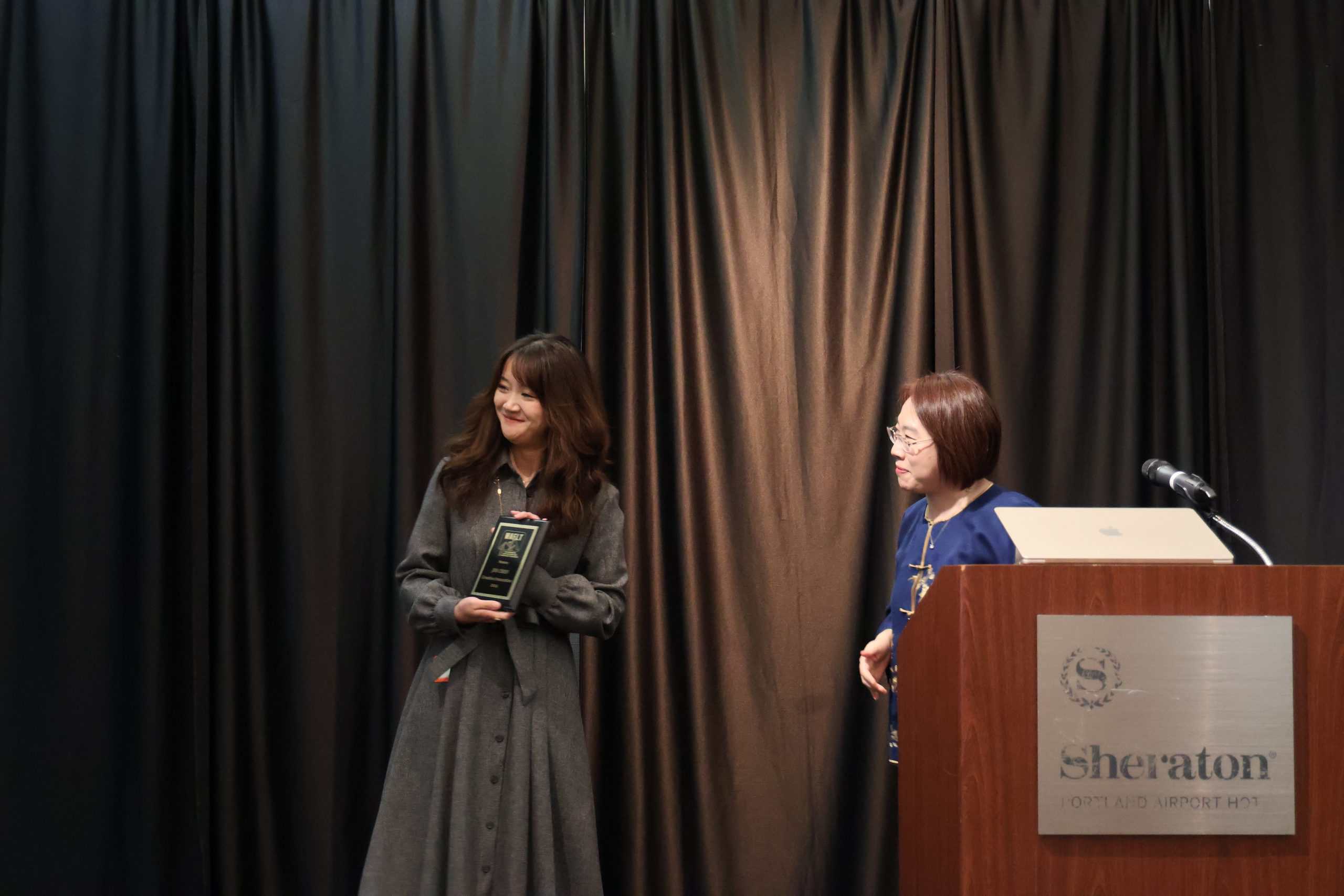 Jin Chen receiving Creative Innovation Award from WAFLT, 2024